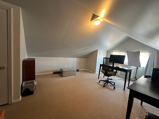 home office featuring lofted ceiling and light carpet