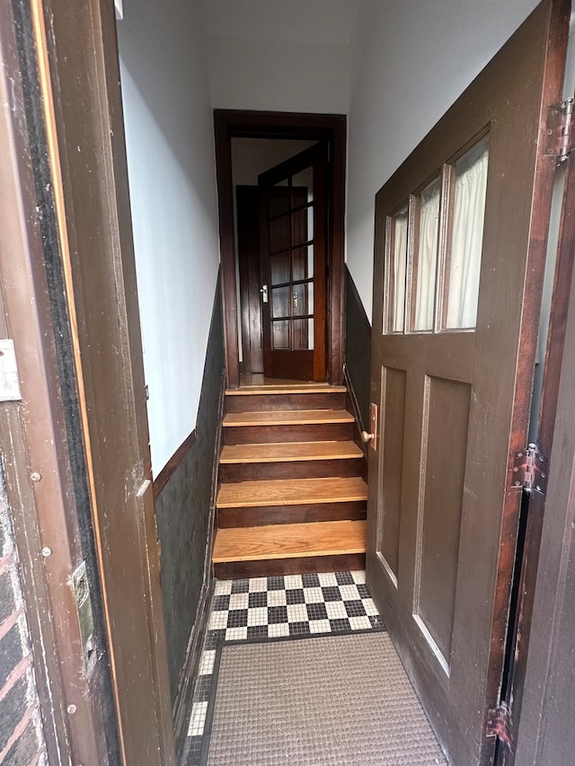 stairs featuring tile patterned flooring