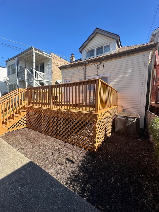 rear view of property featuring a wooden deck