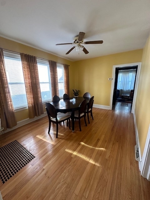 dining area featuring hardwood / wood-style floors and ceiling fan