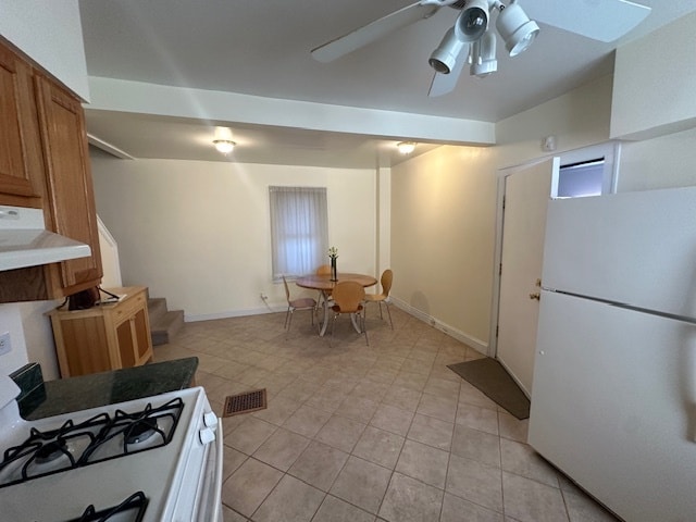 kitchen with a healthy amount of sunlight, range hood, white appliances, and ceiling fan