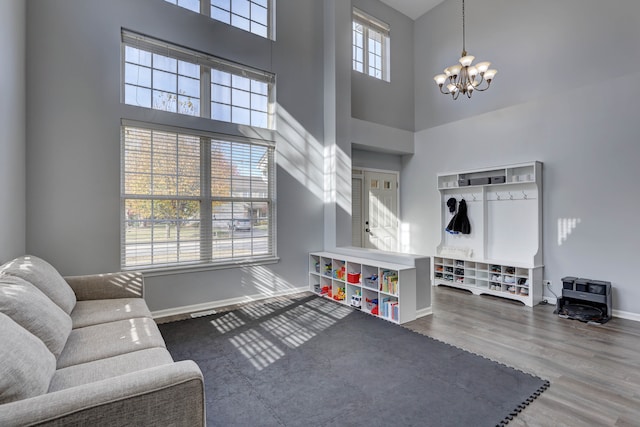 interior space featuring an inviting chandelier, dark hardwood / wood-style floors, and a high ceiling