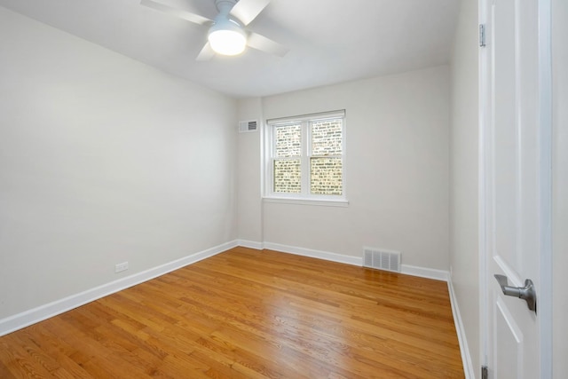 spare room with hardwood / wood-style flooring and ceiling fan