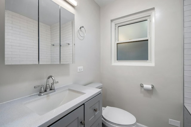 bathroom featuring vanity and toilet