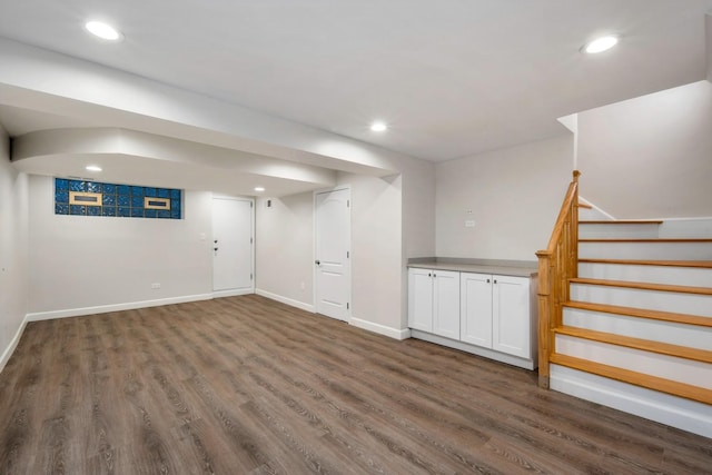 basement with dark hardwood / wood-style flooring