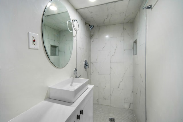 bathroom featuring vanity and a tile shower