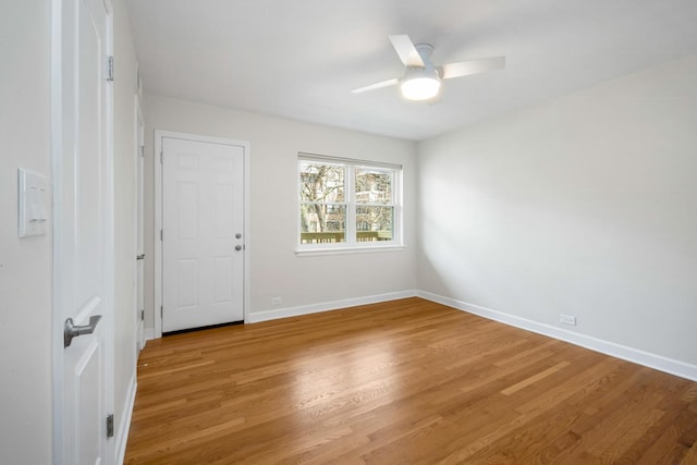 empty room with ceiling fan and light hardwood / wood-style flooring