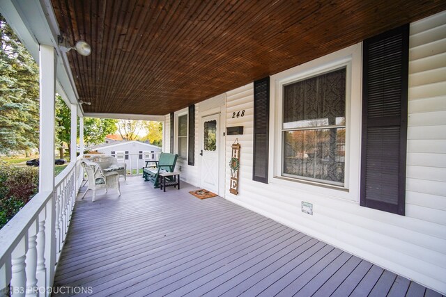 wooden terrace featuring covered porch