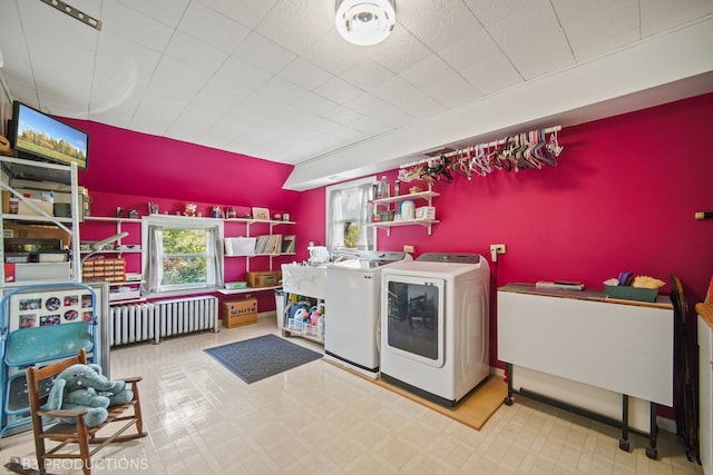 laundry area with radiator and independent washer and dryer