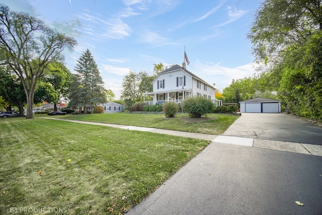 view of front of property with an outdoor structure, a garage, and a front lawn