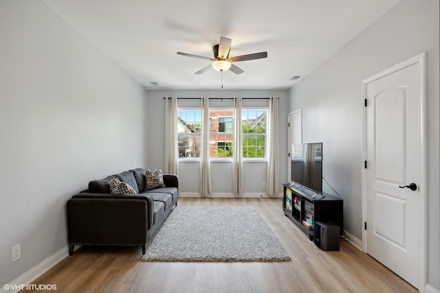 living room with ceiling fan and light wood-type flooring