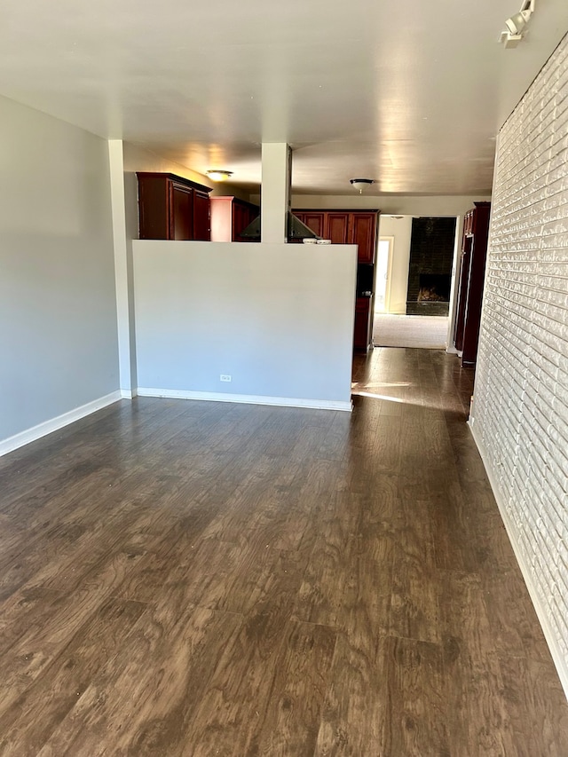 unfurnished living room with dark hardwood / wood-style flooring