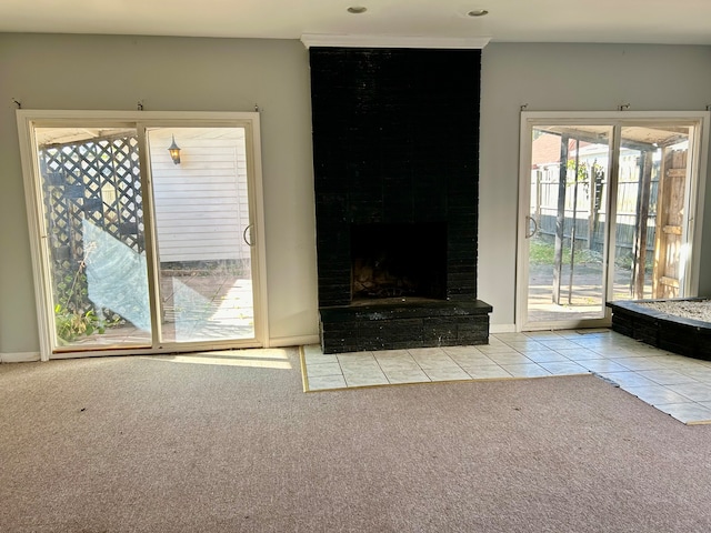 unfurnished living room featuring light tile patterned flooring and a fireplace