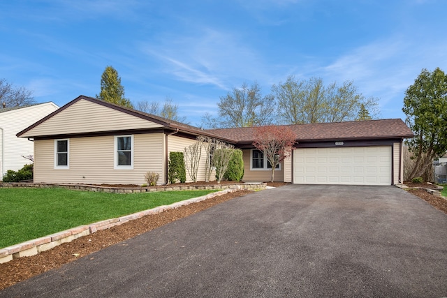 single story home featuring a front yard and a garage