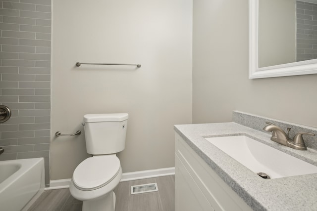 full bathroom with vanity, toilet, tiled shower / bath combo, and hardwood / wood-style floors