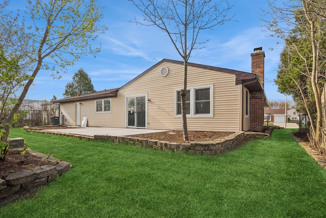 rear view of house featuring a yard, a patio area, and central AC unit