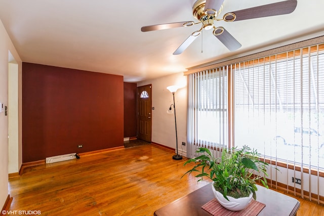 unfurnished living room featuring wood-type flooring and ceiling fan