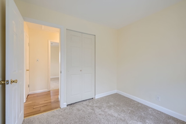 unfurnished bedroom with carpet flooring and a closet