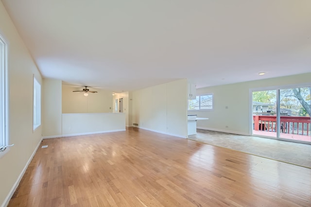 unfurnished living room with ceiling fan and light hardwood / wood-style flooring