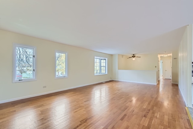 empty room with light hardwood / wood-style flooring and ceiling fan