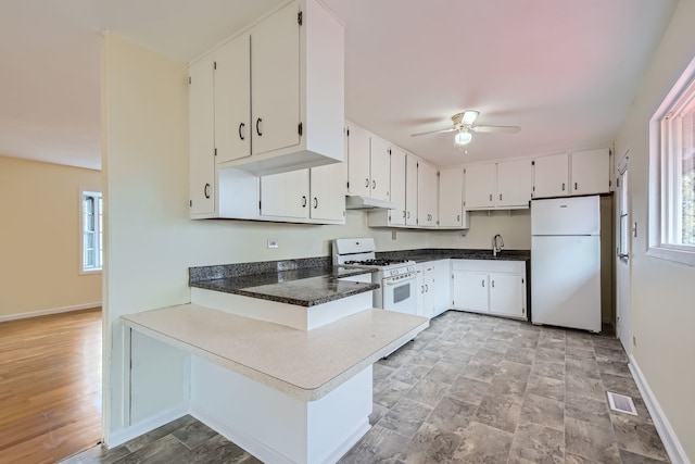 kitchen featuring kitchen peninsula, ceiling fan, white appliances, white cabinets, and light wood-type flooring