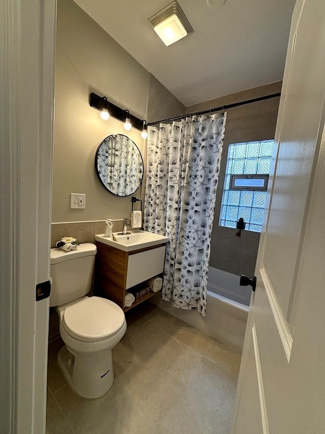 full bathroom with vanity, shower / bath combination with curtain, toilet, and tile patterned flooring