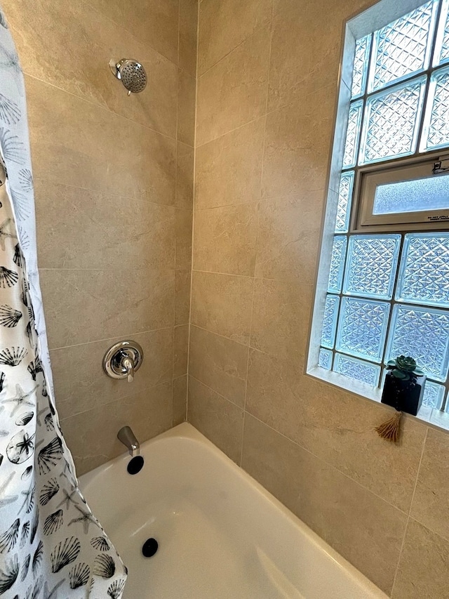 bathroom with shower / bath combination with curtain