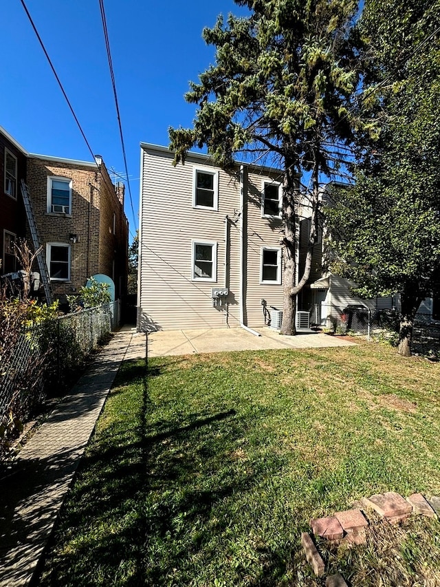 rear view of property with a yard