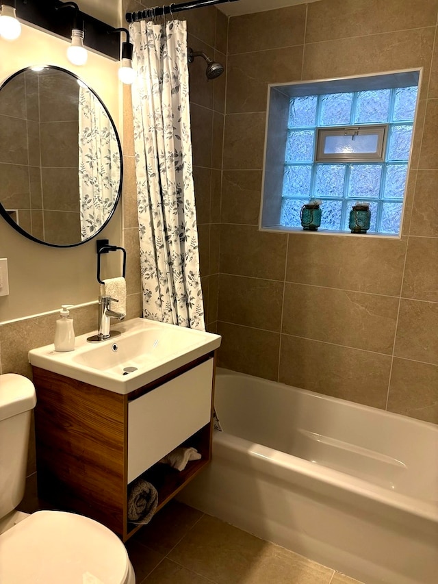 full bathroom with toilet, shower / tub combo with curtain, vanity, and tile patterned flooring