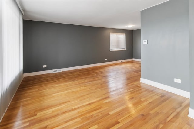 empty room with light hardwood / wood-style flooring