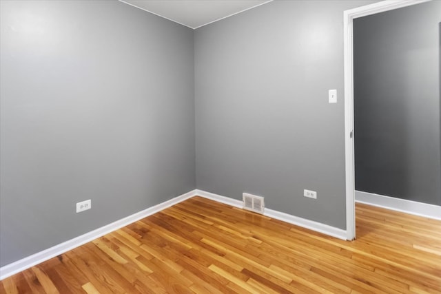 empty room with wood-type flooring