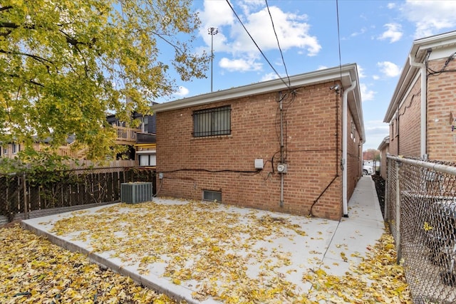 back of property featuring cooling unit and a patio area