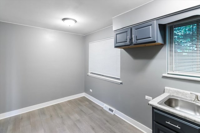 kitchen with sink and light hardwood / wood-style flooring