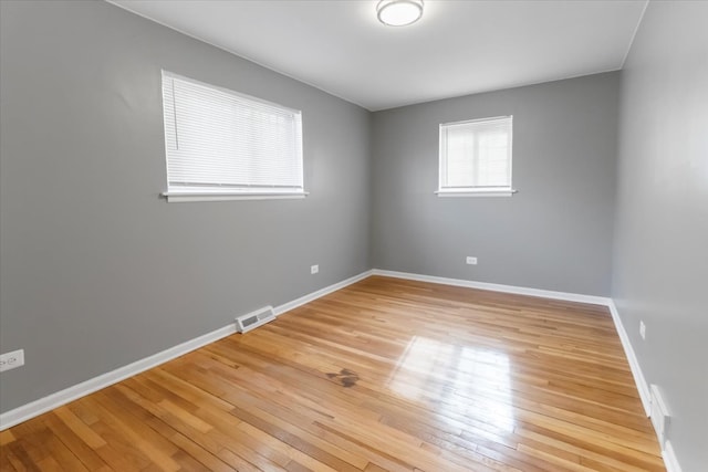 unfurnished room with wood-type flooring