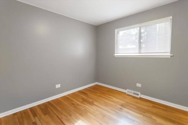 spare room featuring light hardwood / wood-style floors