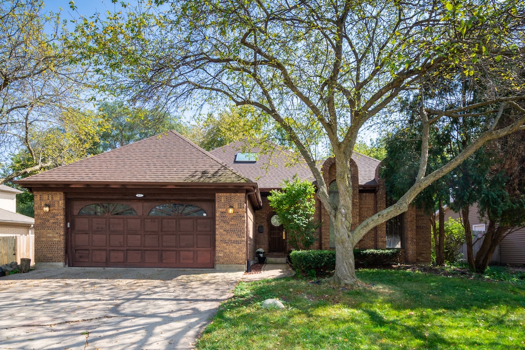 view of front of property with a front yard and a garage