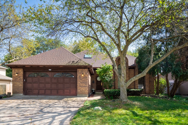 view of front of property with a front yard and a garage