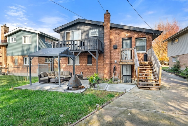 back of house with a patio, an outdoor living space, and a lawn