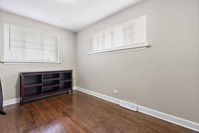 unfurnished room with dark hardwood / wood-style floors and plenty of natural light