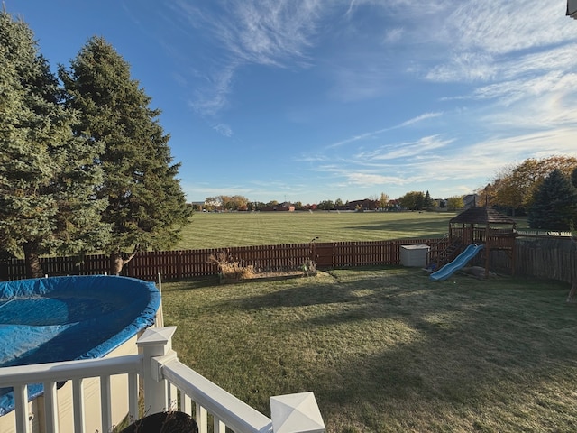 view of yard featuring a covered pool and a rural view