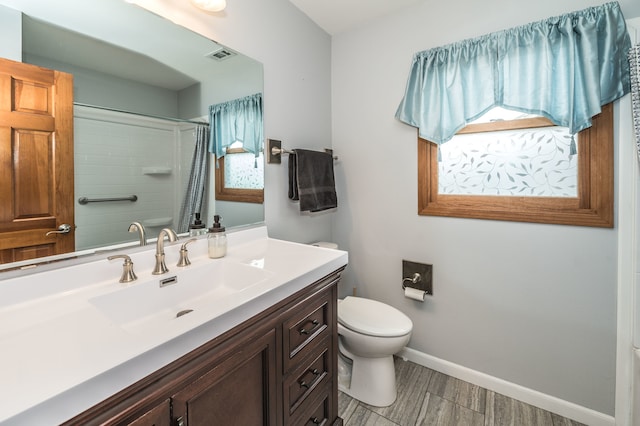 bathroom with vanity, curtained shower, toilet, and hardwood / wood-style flooring