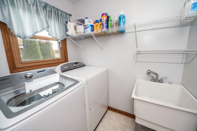 clothes washing area with washer and dryer and sink