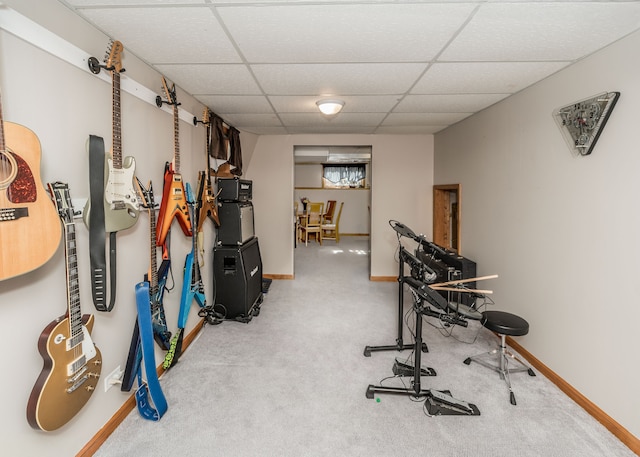 exercise room featuring carpet and a drop ceiling