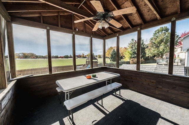 unfurnished sunroom with lofted ceiling, a healthy amount of sunlight, and ceiling fan