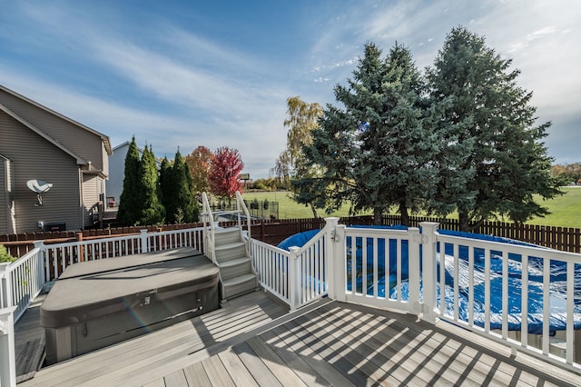 wooden terrace featuring a swimming pool with hot tub