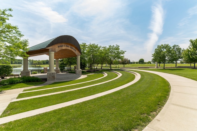 view of property's community featuring a gazebo, a lawn, and a water view