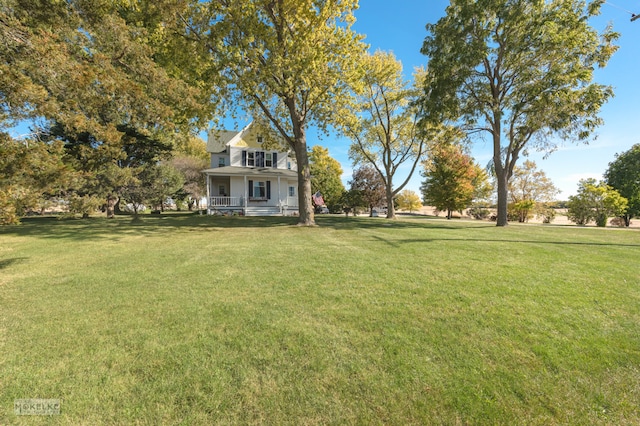 view of yard featuring covered porch