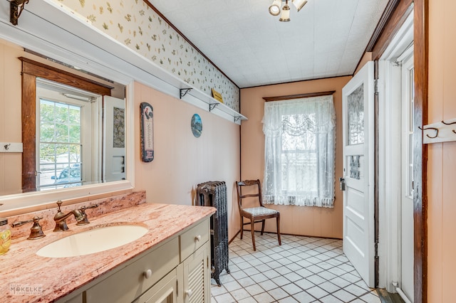 bathroom with tile patterned flooring, vanity, and crown molding