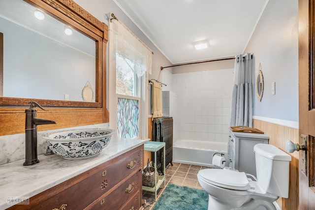 full bathroom featuring wood walls, tile patterned flooring, shower / tub combo, vanity, and toilet