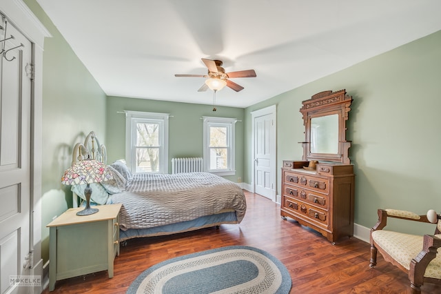 bedroom featuring ceiling fan, radiator, and dark hardwood / wood-style floors